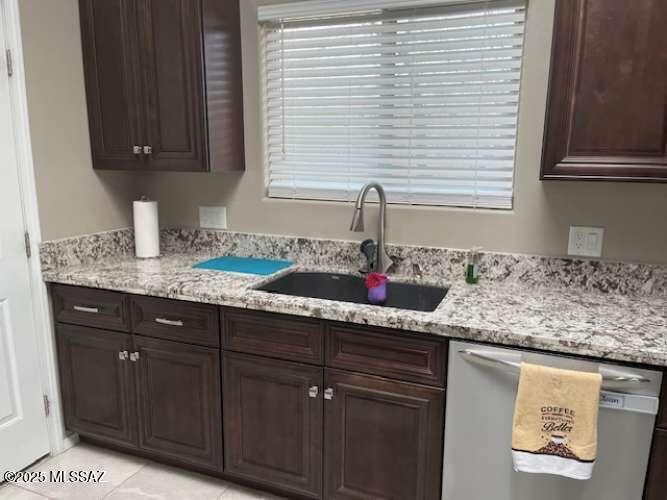 11553 East Tanque Verde Road Tucson, AZ 85749 - Photo 14 of 16 a kitchen with granite countertop cabinets sink and window