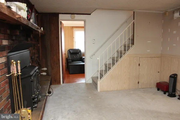 a view of a livingroom with furniture and staircase