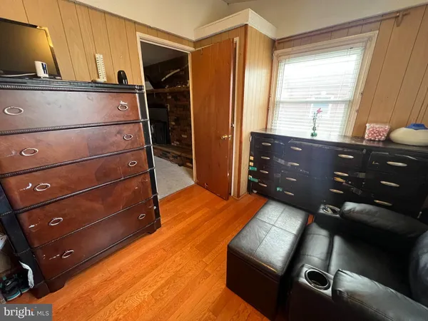 a room with a bed window and a television