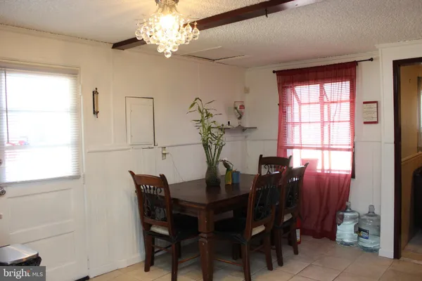a view of a dining room with furniture and chandelier