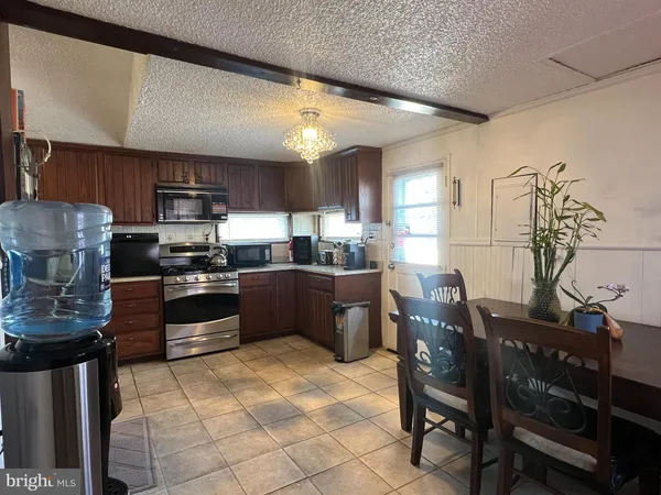 a kitchen with stainless steel appliances kitchen island granite countertop a sink counter space and cabinets