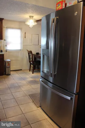 a kitchen with stainless steel appliances granite countertop a refrigerator and a stove