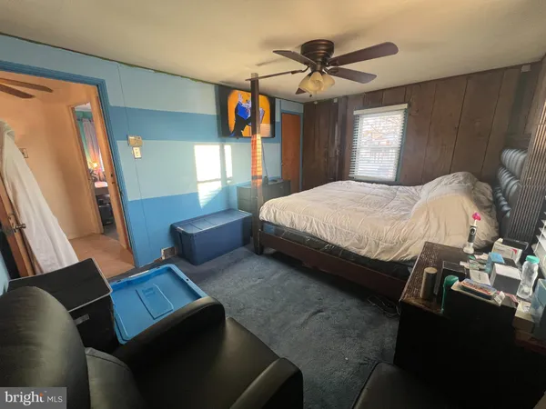 a bedroom with bed and window