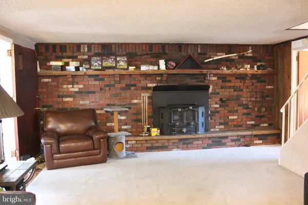 a living room with fireplace furniture and a flat screen tv