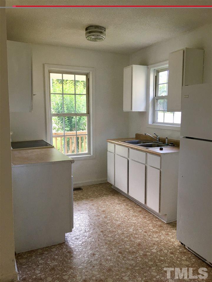 626 Bragg Street Raleigh, NC 27610 - Photo 2 of 3 a kitchen with stainless steel appliances granite countertop a sink stove and cabinets