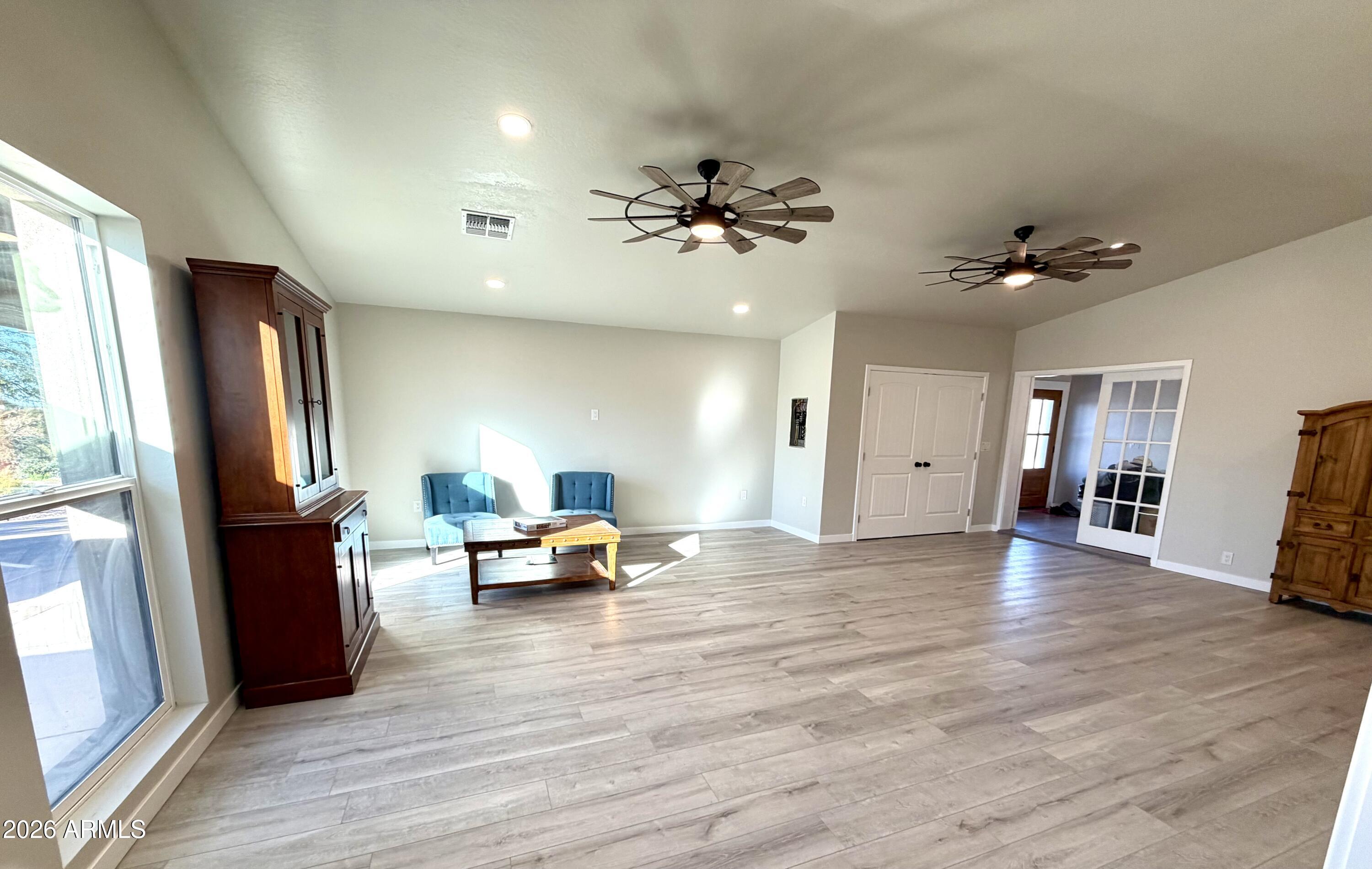 1165 North Mountain View Road Apache Junction, AZ 85119 - Photo 10 of 29 a view of a livingroom with furniture a ceiling fan and window