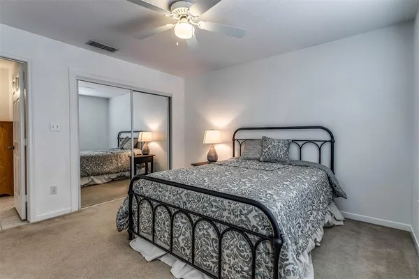 a bedroom with a bed and a mirror
