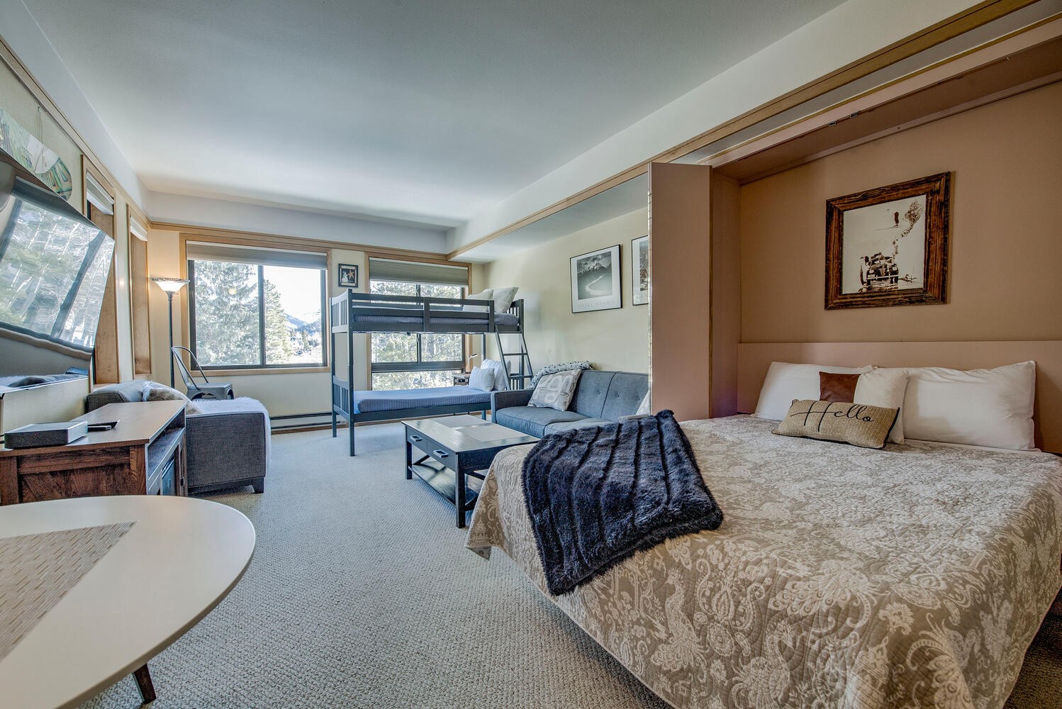 a bedroom with a large bed couch and a window