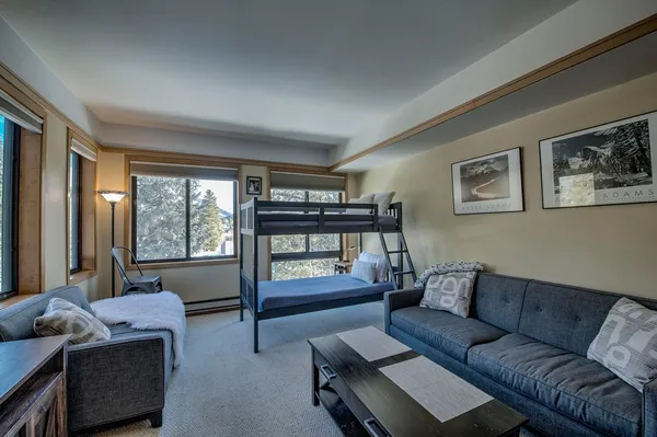 a bedroom with bed and a mirror