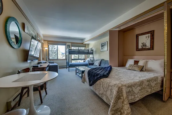 a bedroom with a bed and the painting on the wall