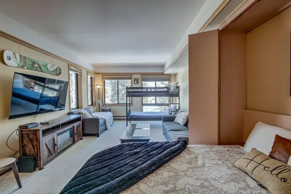 a bedroom with a bed and painting on the wall