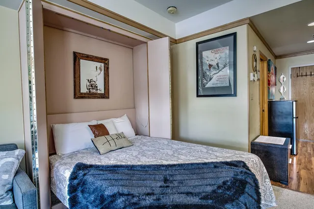 a view of a hallway with entryway wooden floor and a dining table