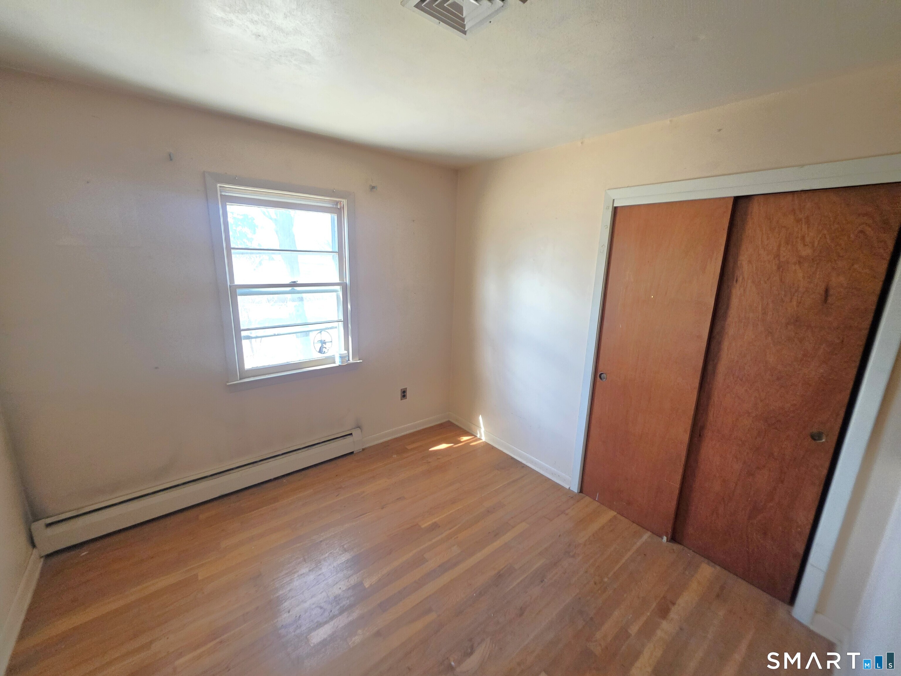 12 Brentwood Road New Milford, CT 06776 - Photo 15 of 21 an empty room with wooden floor and windows