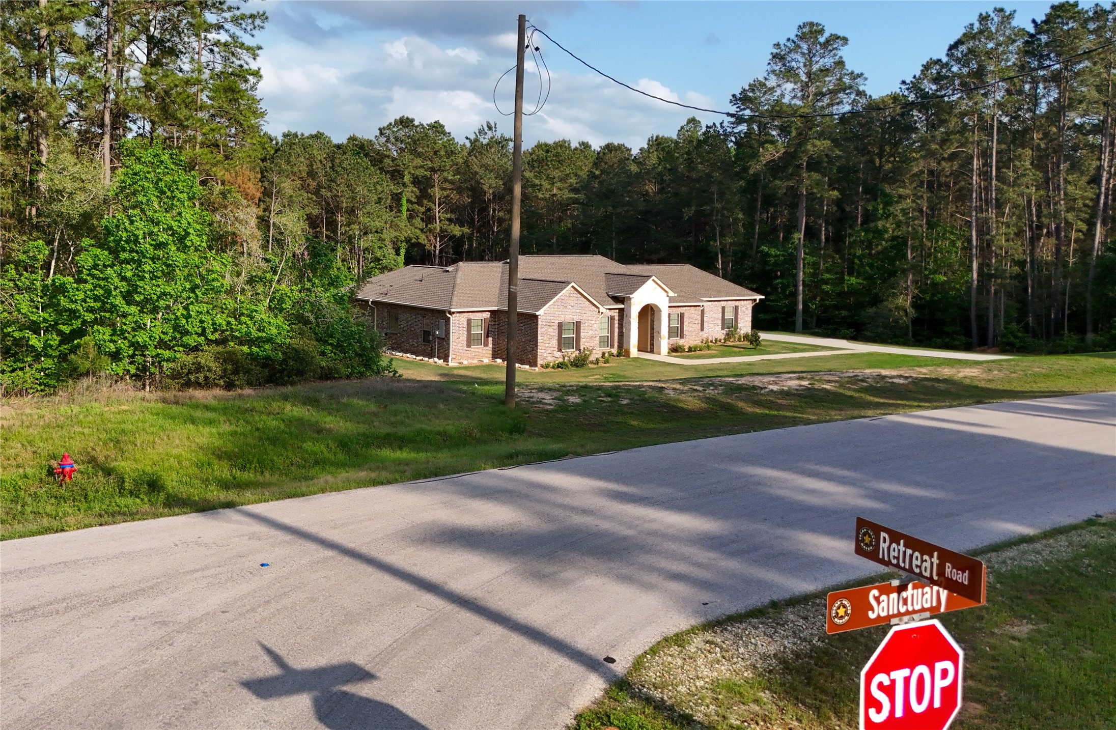 120 Sanctuary Road Huntsville, TX 77340 - Photo 34 of 38 a front view of a house with a yard and garage