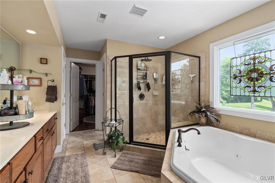 6081 Upper Ridge Road Green Lane, PA 18054 - Photo 27 of 39 a bathroom with a tub a sink shower and a mirror