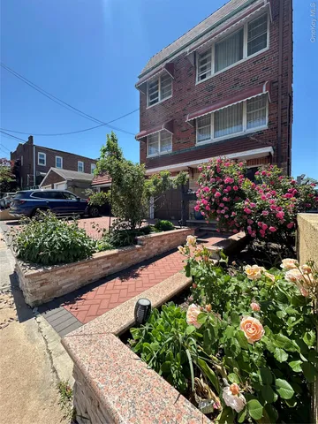 a view of a house with a yard and garden