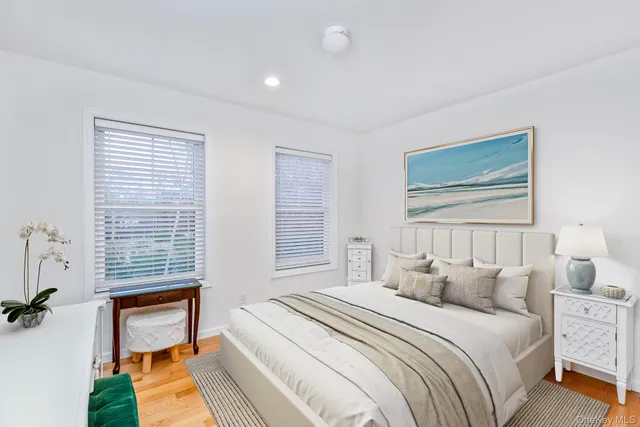 a bedroom with a bed and a window with chair