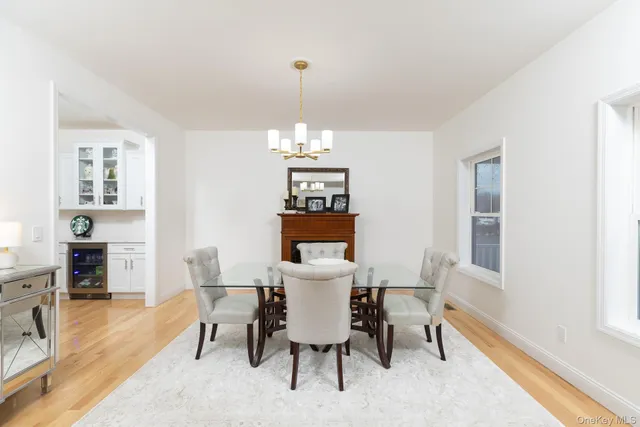 a view of a dining room with furniture a chandelier and wooden floor