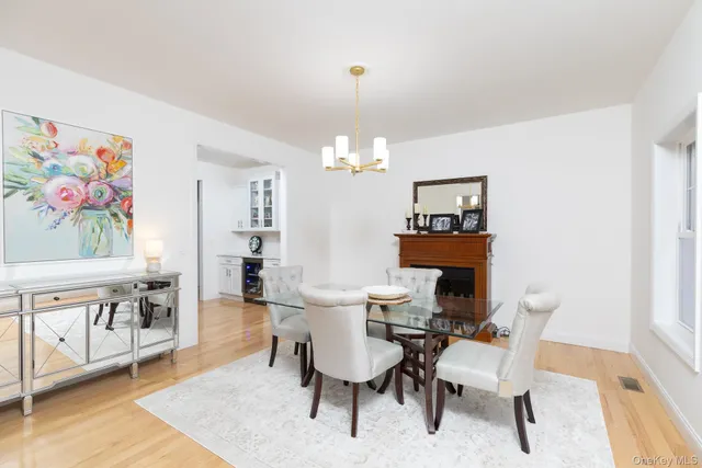 a view of a dining room with furniture a rug and wooden floor