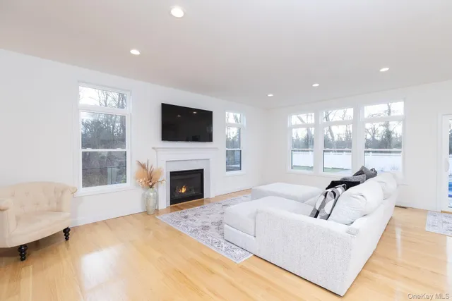 a living room with furniture a fireplace and a flat screen tv
