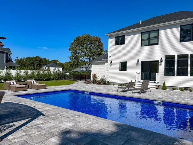 a view of house with swimming pool yard and outdoor seating