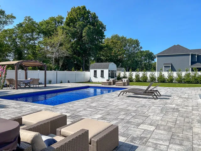 a view of swimming pool with chairs