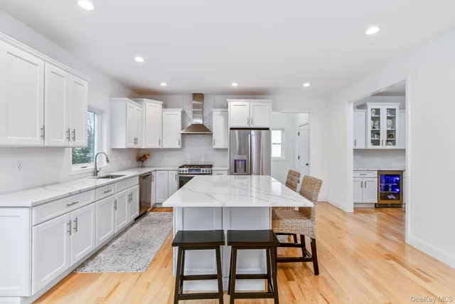 a large kitchen with kitchen island a table and chairs in it