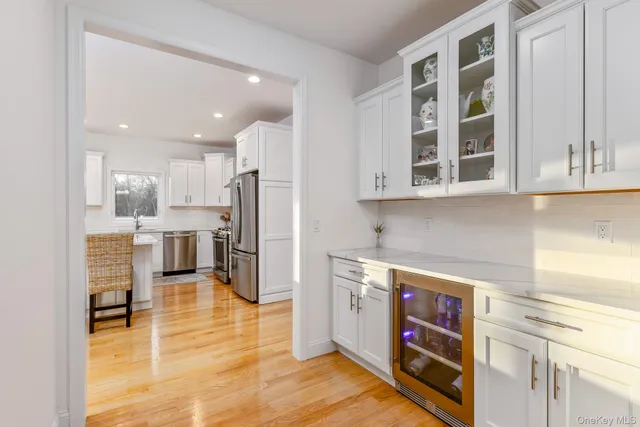 a kitchen with stainless steel appliances granite countertop a refrigerator and a stove top oven