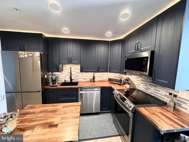 a kitchen with a refrigerator and a sink