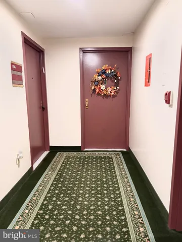 a view of a closet with wooden floor