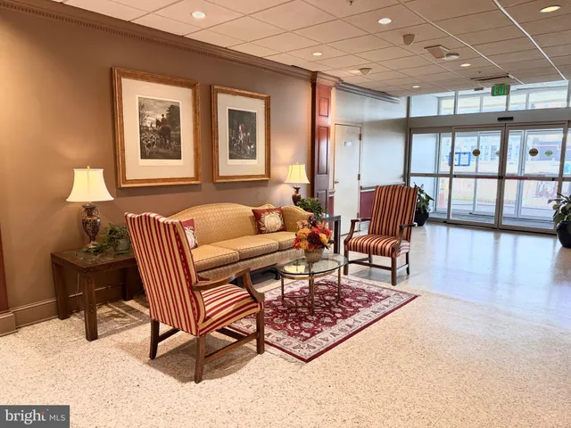 a living room with a book shelf and a book shelf