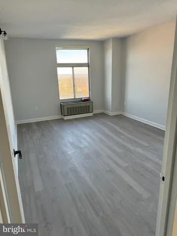 a kitchen with stainless steel appliances a refrigerator a sink and white cabinets