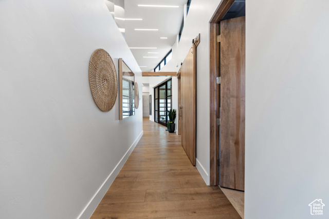 3558 South Cypress Road Hurricane, UT 84737 - Photo 15 of 57 Hallway with a barn door and light wood-type flooring
