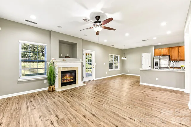 a kitchen with stainless steel appliances granite countertop a refrigerator and wooden cabinets