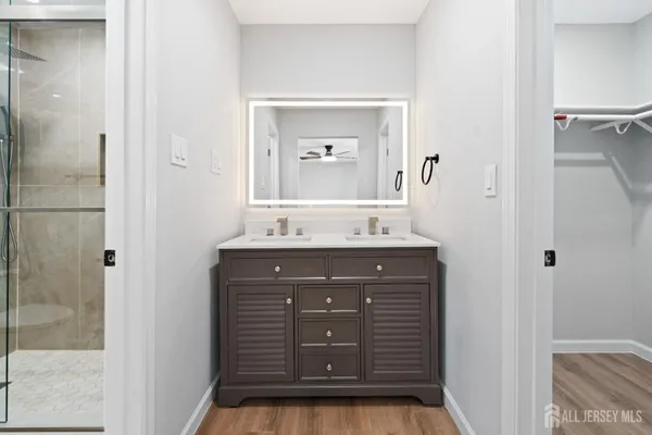 a bathroom with a sink a vanity and a mirror