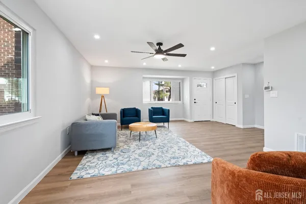a living room with furniture and wooden floor