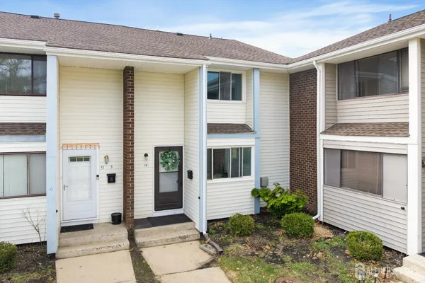 a front view of a house with a glass windows and yard