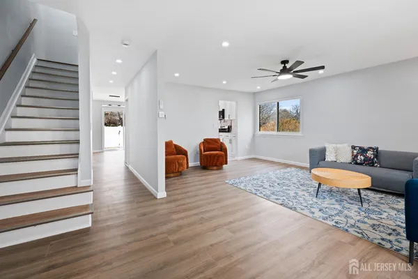 a view of a room with wooden floor and furniture