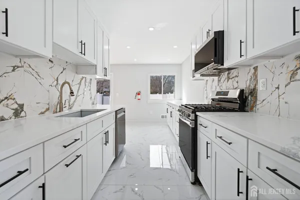 a kitchen with cabinets and a stove