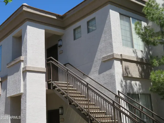 a view of balcony with wooden floor and fence