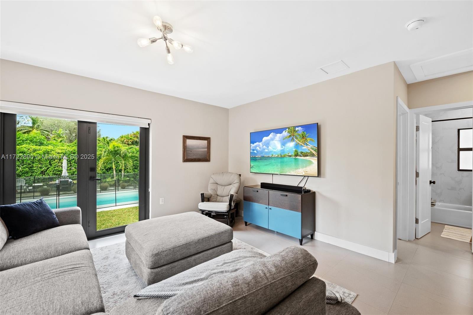 620 Cardinal Street Miami Springs, FL 33166 - Photo 11 of 24 a living room with furniture and a flat screen tv