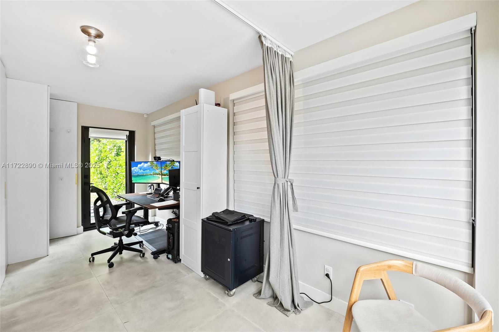 620 Cardinal Street Miami Springs, FL 33166 - Photo 19 of 24 a view of a workspace with furniture and a window