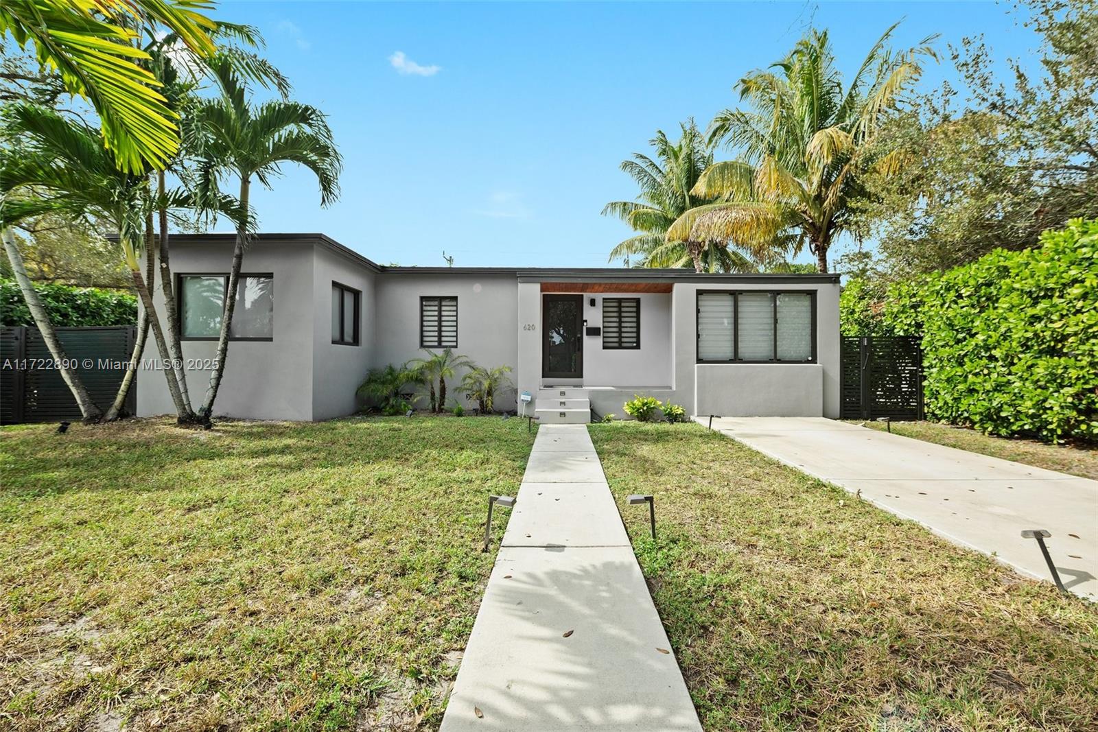620 Cardinal Street Miami Springs, FL 33166 - Photo 3 of 24 a view of a house with a yard and potted plants