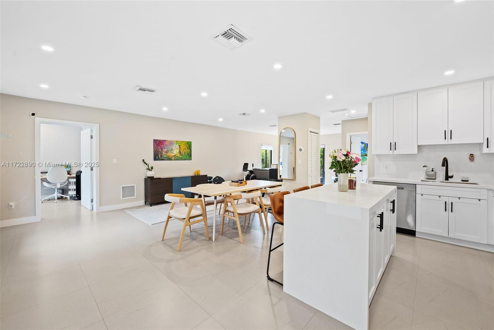 620 Cardinal Street Miami Springs, FL 33166 - Photo 6 of 24 a large white kitchen with lots of counter top space and stainless steel appliances