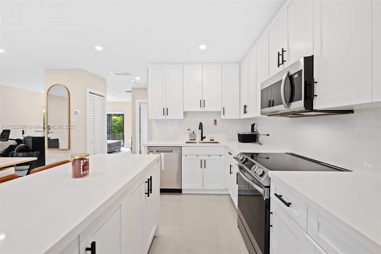 620 Cardinal Street Miami Springs, FL 33166 - Photo 8 of 24 a kitchen with stainless steel appliances white cabinets and sink