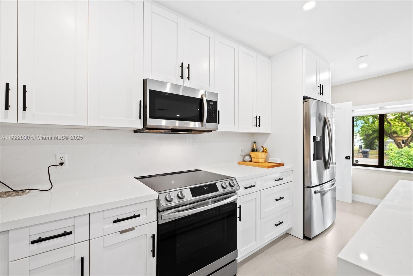 620 Cardinal Street Miami Springs, FL 33166 - Photo 9 of 24 a kitchen with stainless steel appliances a stove microwave and refrigerator