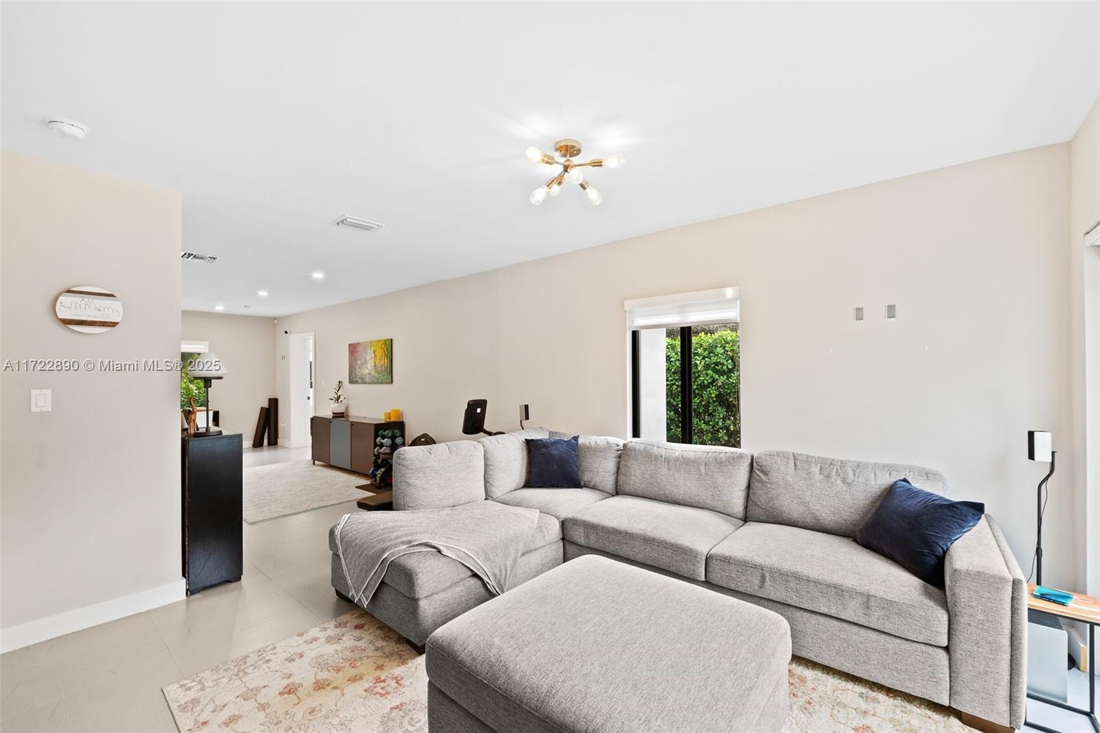 620 Cardinal Street Miami Springs, FL 33166 - Photo 10 of 24 a living room with furniture a couch and a window