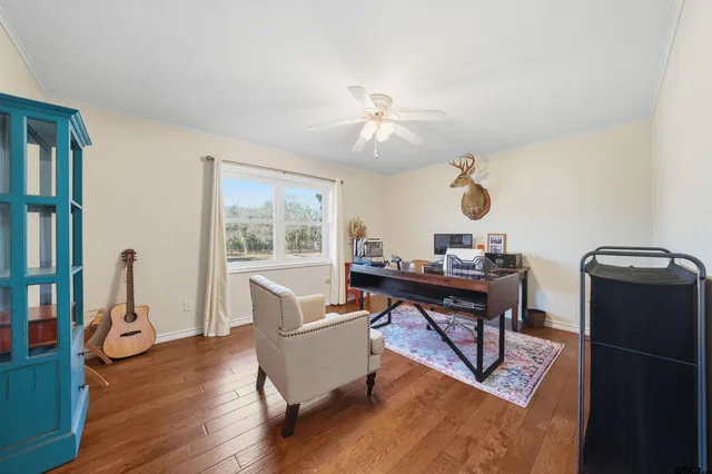 a view of a workspace with furniture and a window