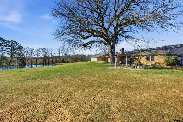 a view of yard with swimming pool and green space