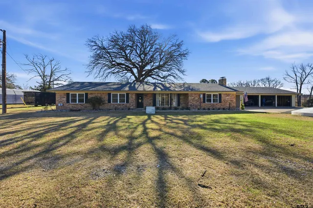 a front view of a house with a yard table and chairs